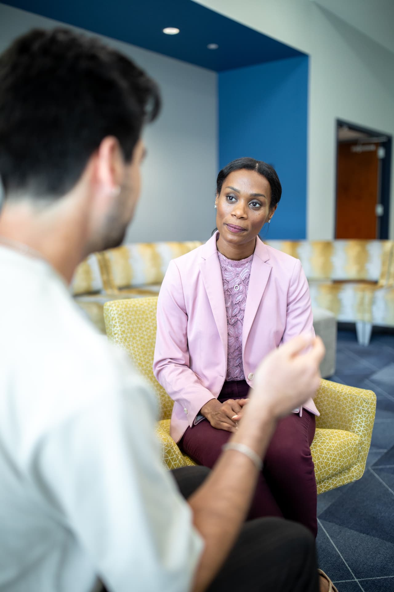 A counseling student and professor walking together in conversation