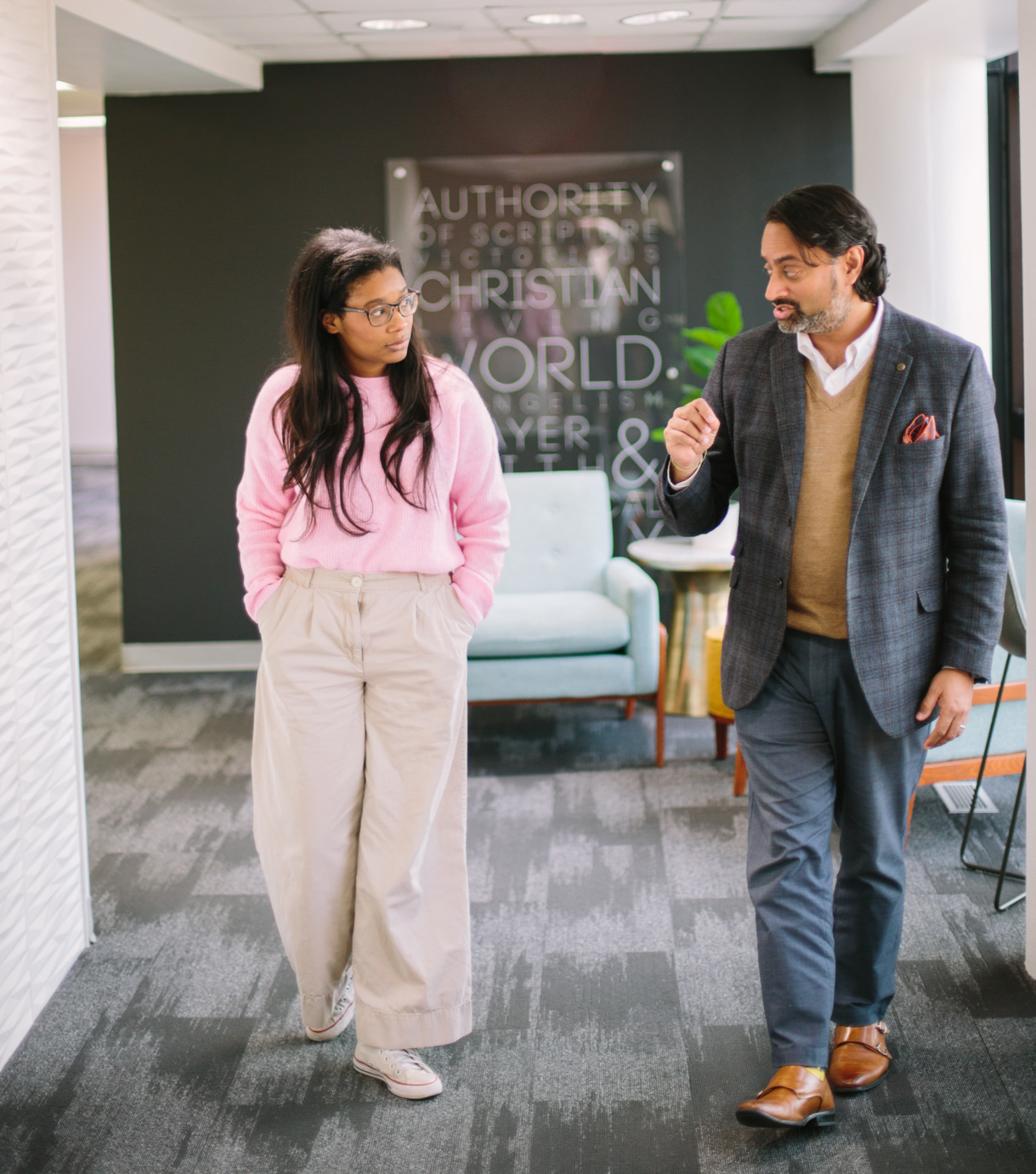 A counseling student and professor walking together in conversation